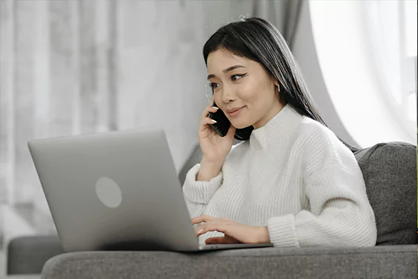 A woman talking happily using her phone