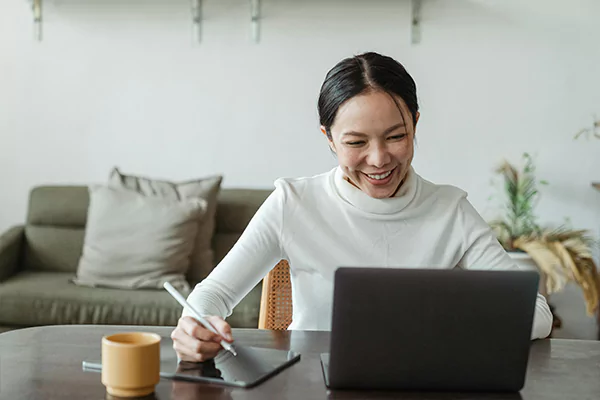 A woman using her laptop on the table